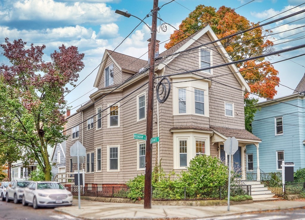 31-33 Rockingham Street Cambridge, MA 02139 - Photo 3 of 22 a front view of a house with a yard and potted plants