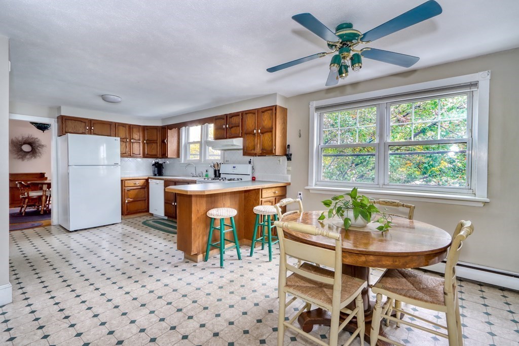 31-33 Rockingham Street Cambridge, MA 02139 - Photo 5 of 22 a kitchen with a dining table chairs and refrigerator