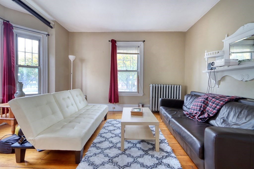 31-33 Rockingham Street Cambridge, MA 02139 - Photo 9 of 22 a living room with furniture and a window
