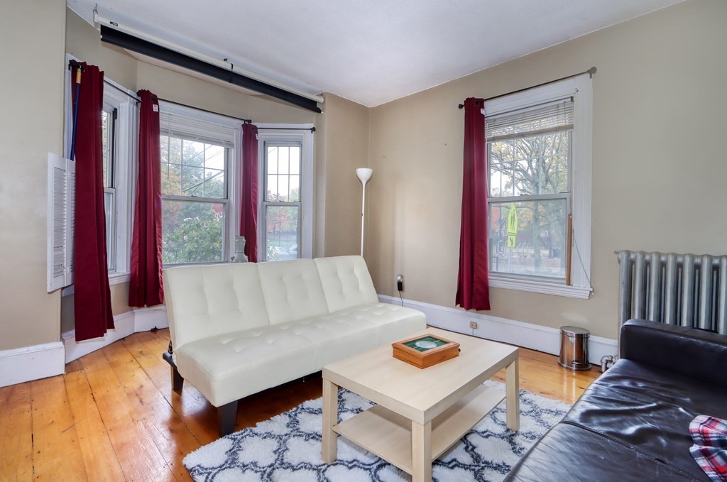 31-33 Rockingham Street Cambridge, MA 02139 - Photo 10 of 22 a living room with furniture and a window