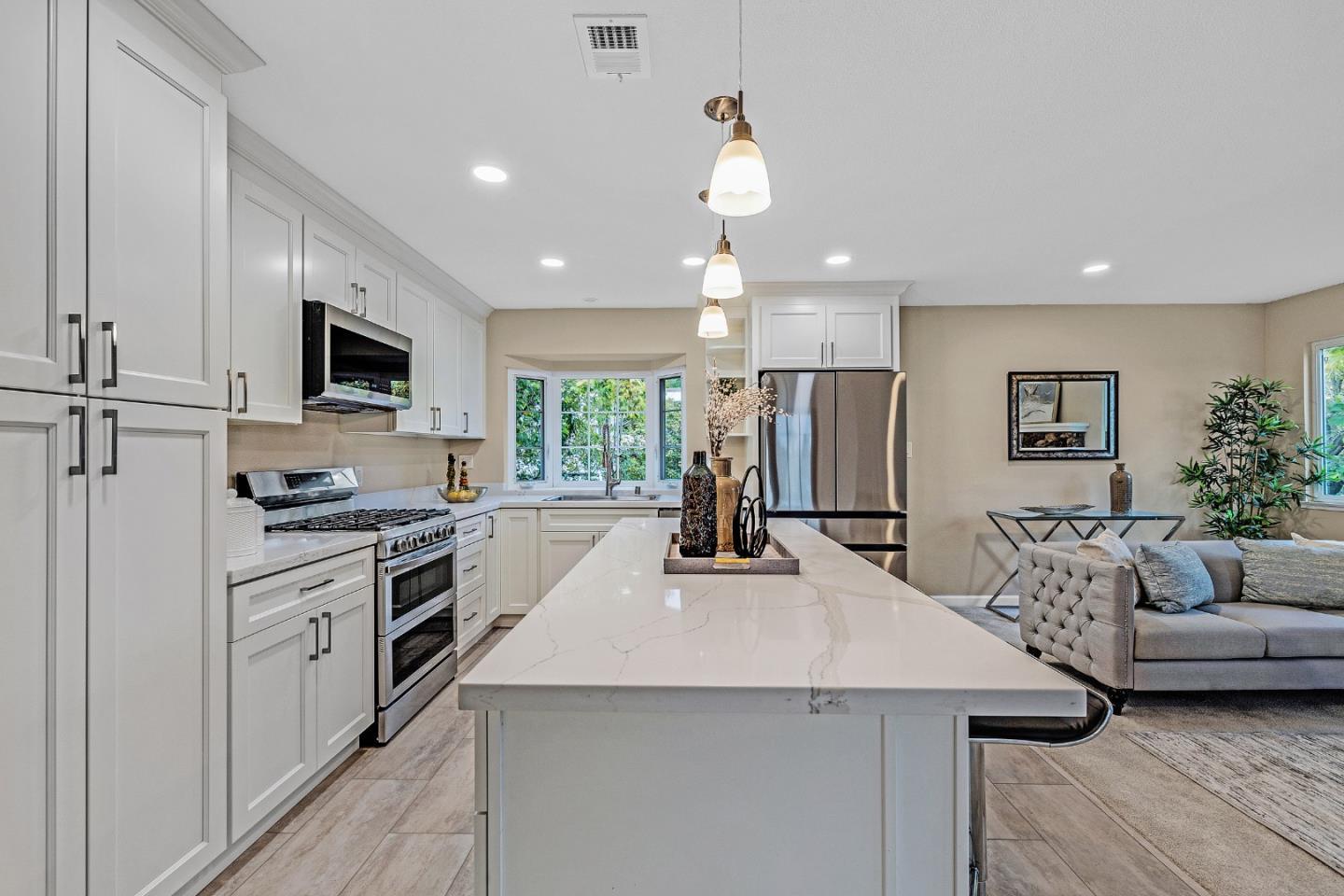 180 Mill Creek Road Fremont, CA 94539 - Photo 13 of 55 a kitchen with a sink a counter top space stainless steel appliances and a window