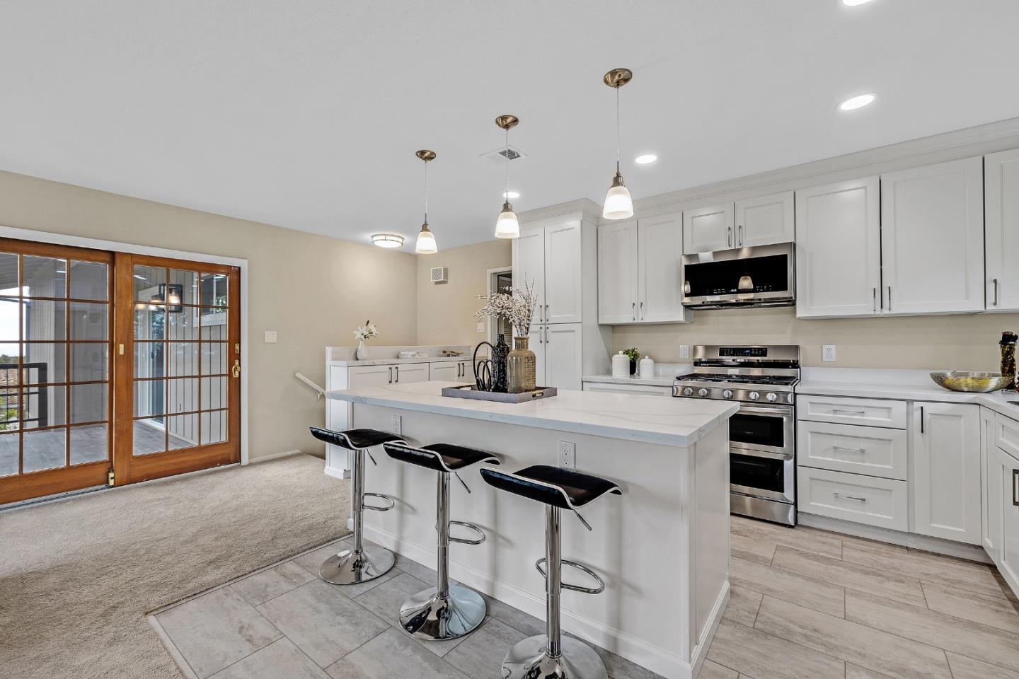 180 Mill Creek Road Fremont, CA 94539 - Photo 9 of 55 a kitchen with kitchen island a stove a table and chairs in it