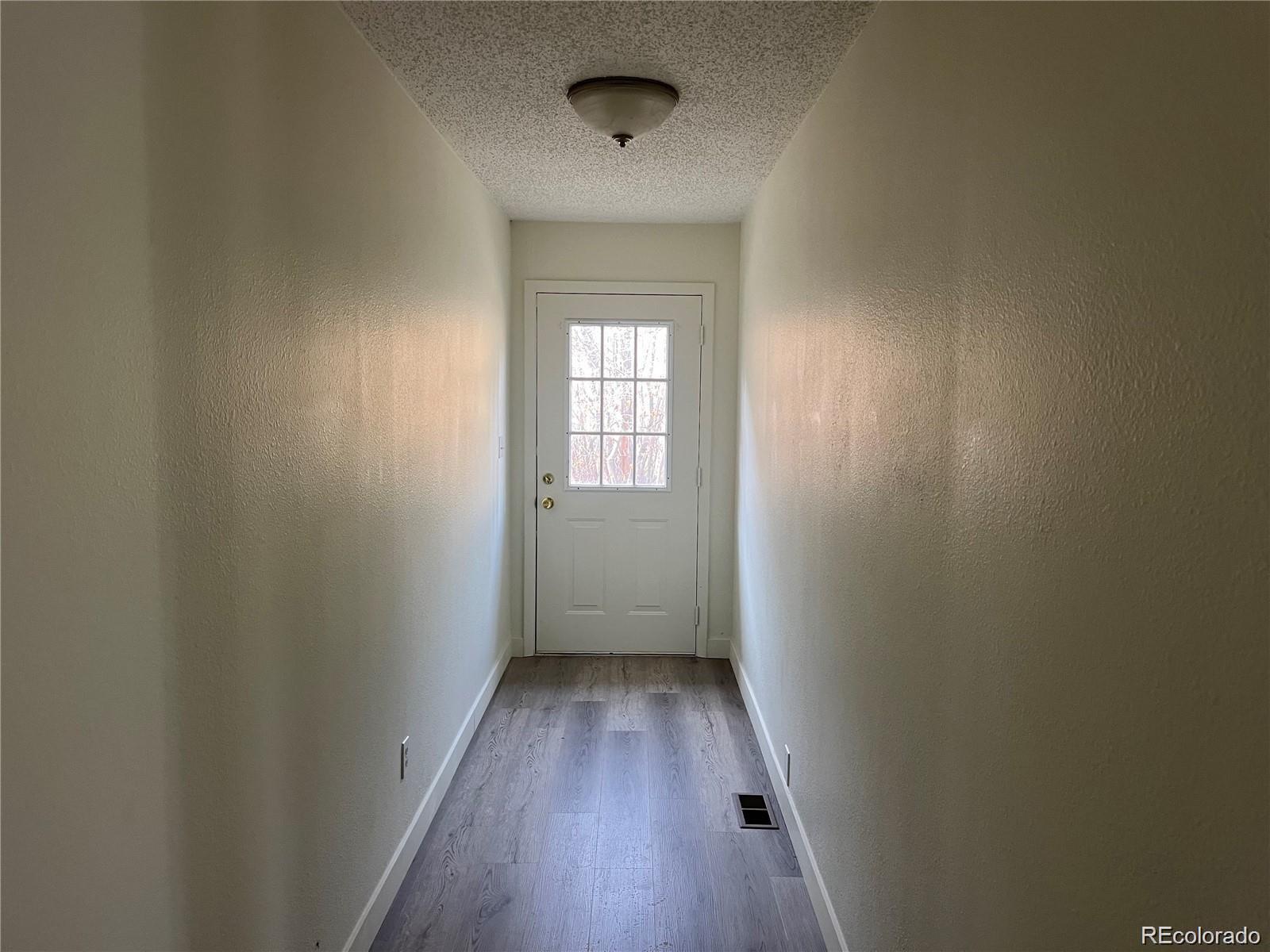 24395 Main Street Elbert, CO 80106 - Photo 18 of 26 a view of a hallway with wooden floor and a window
