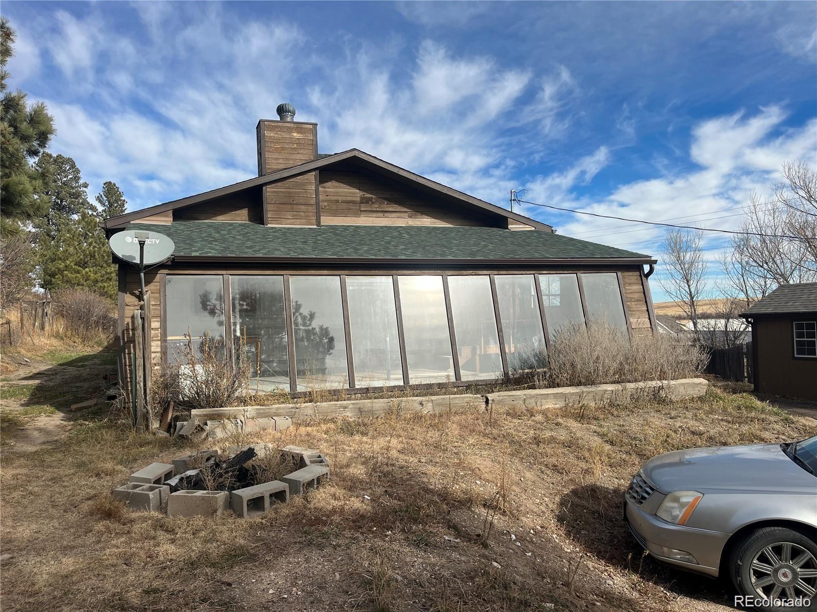 24395 Main Street Elbert, CO 80106 - Photo 2 of 26 a front view of a house with parking area