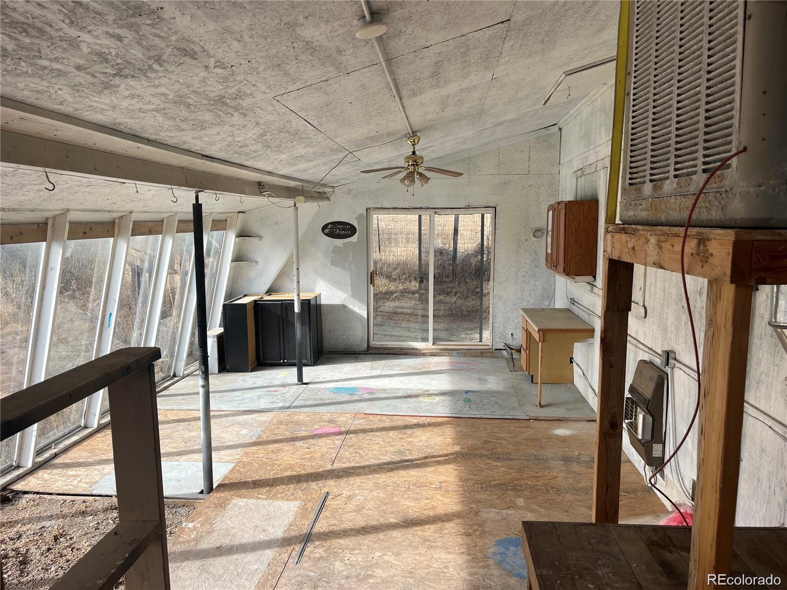 24395 Main Street Elbert, CO 80106 - Photo 22 of 26 a view of living room with furniture and a floor to ceiling window