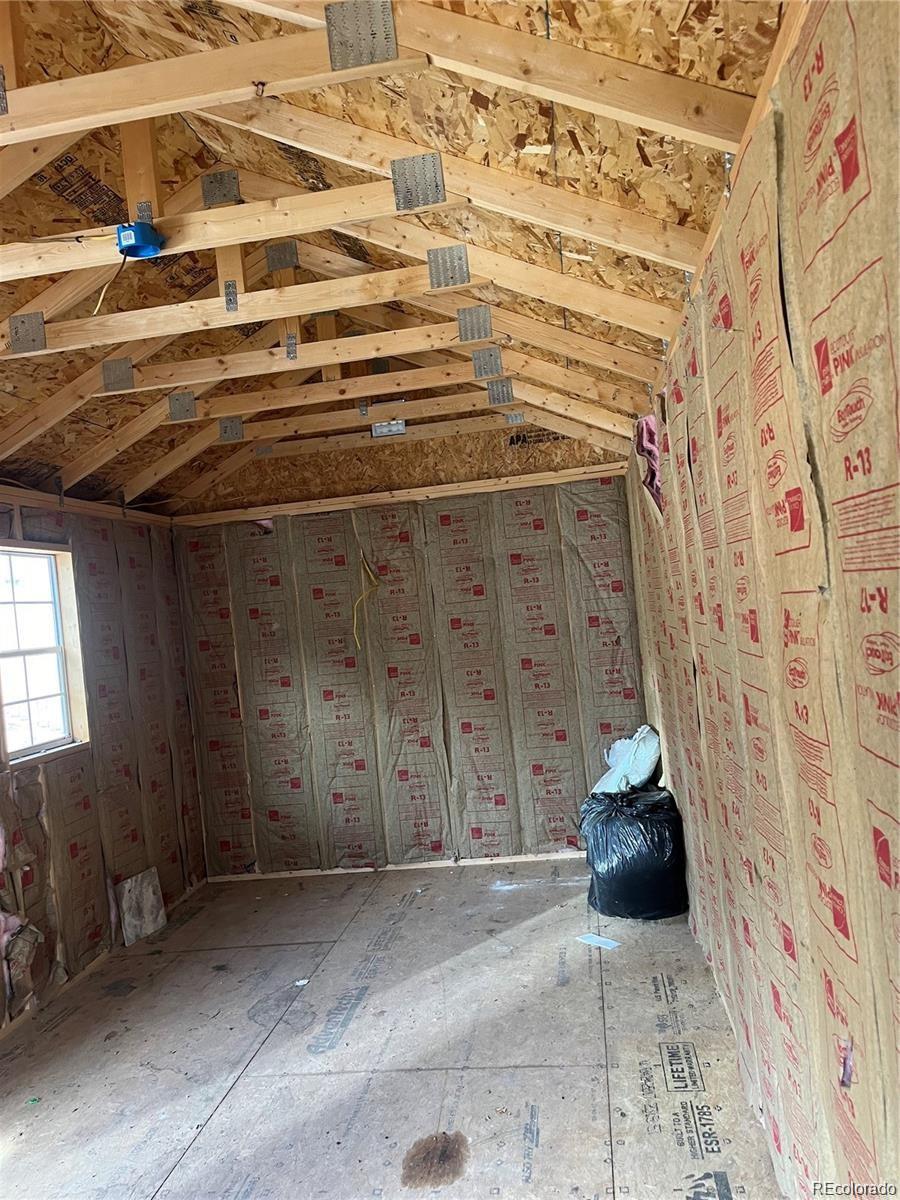 24395 Main Street Elbert, CO 80106 - Photo 23 of 26 a view of a room with wooden walls and stairs