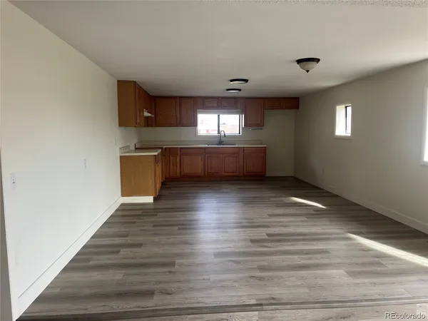 a view of room with window and wooden floor