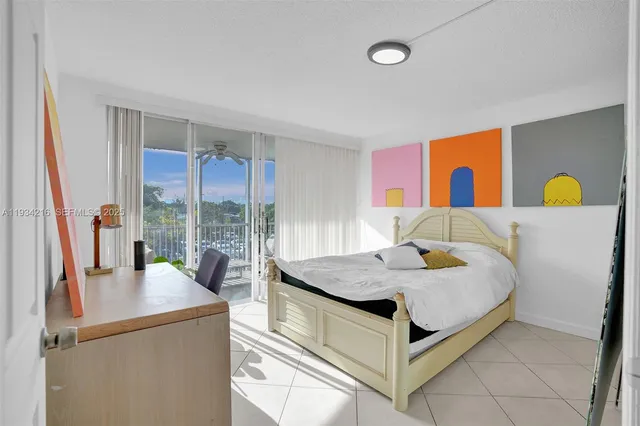 a bedroom with a bed and dresser with mirror