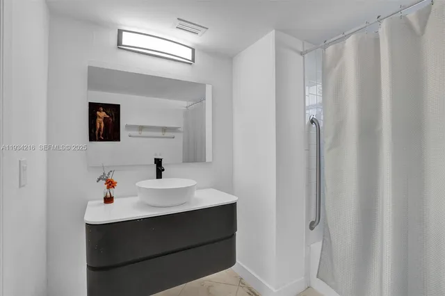 a bathroom with a sink vanity and a mirror