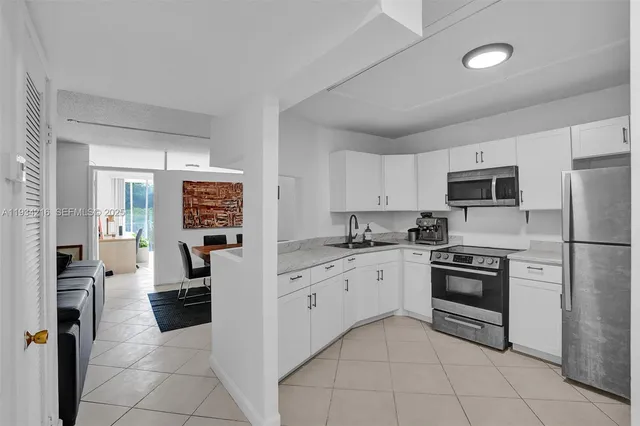 a kitchen with cabinets stainless steel appliances and a counter top space
