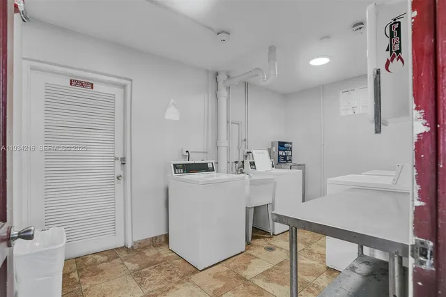 a kitchen with a sink cabinets and appliances