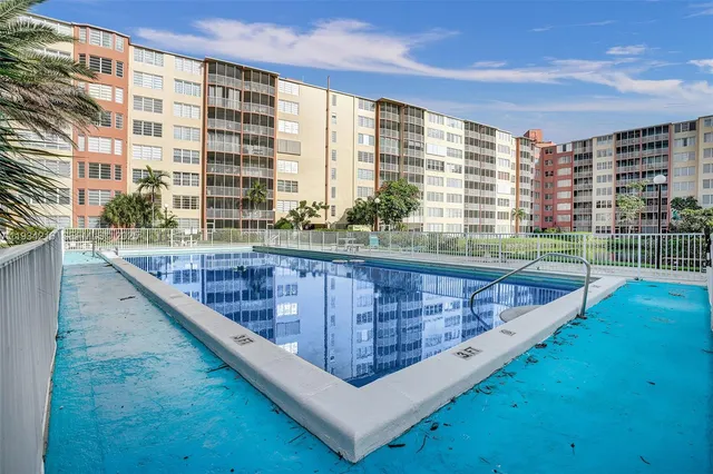 a view of balcony with a couple of swimming pool