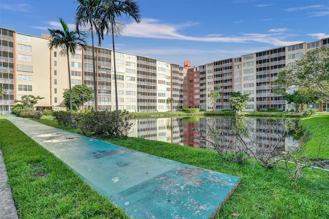 a front view of a house with a yard and potted plants