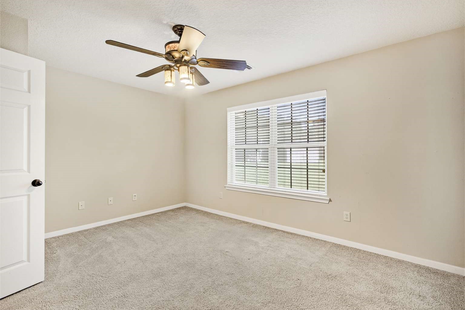 329 Gou Hole Road Cove, TX 77523 - Photo 6 of 19 an empty room with a window and a fan