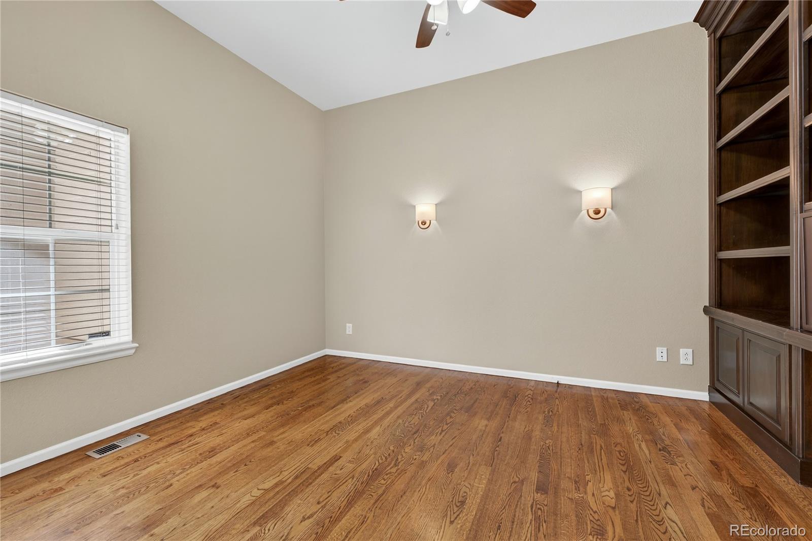 10155 Joseph Drive Highlands Ranch, CO 80124 - Photo 11 of 50 an empty room with wooden floor and windows