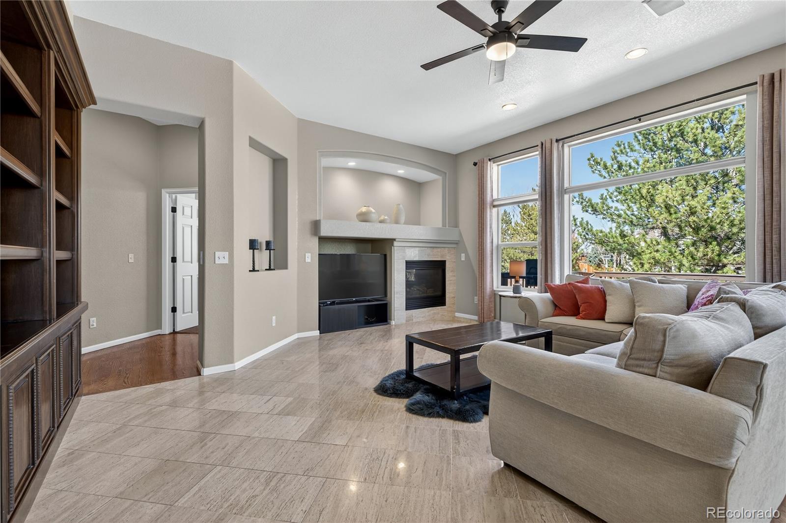 10155 Joseph Drive Highlands Ranch, CO 80124 - Photo 16 of 50 a living room with furniture and a fireplace