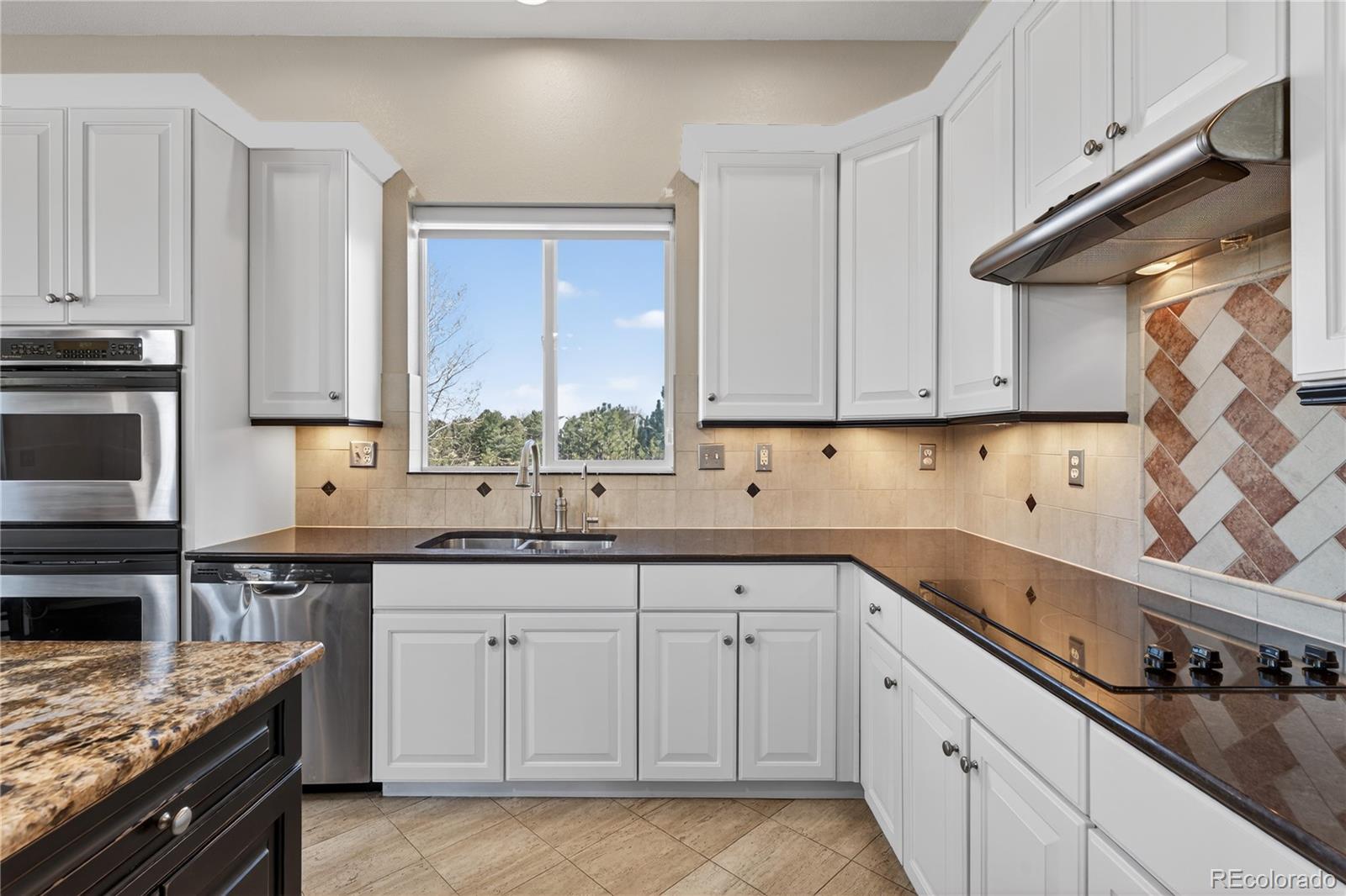 10155 Joseph Drive Highlands Ranch, CO 80124 - Photo 21 of 50 a kitchen with a sink stove and cabinets