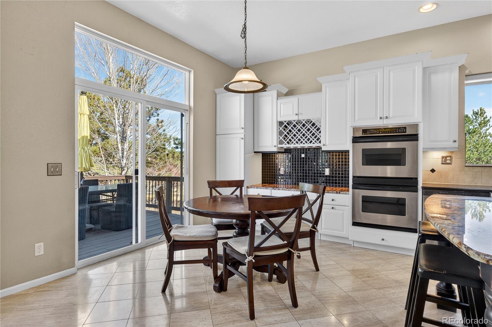 10155 Joseph Drive Highlands Ranch, CO 80124 - Photo 25 of 50 a view of a dining room with furniture window and wooden floor