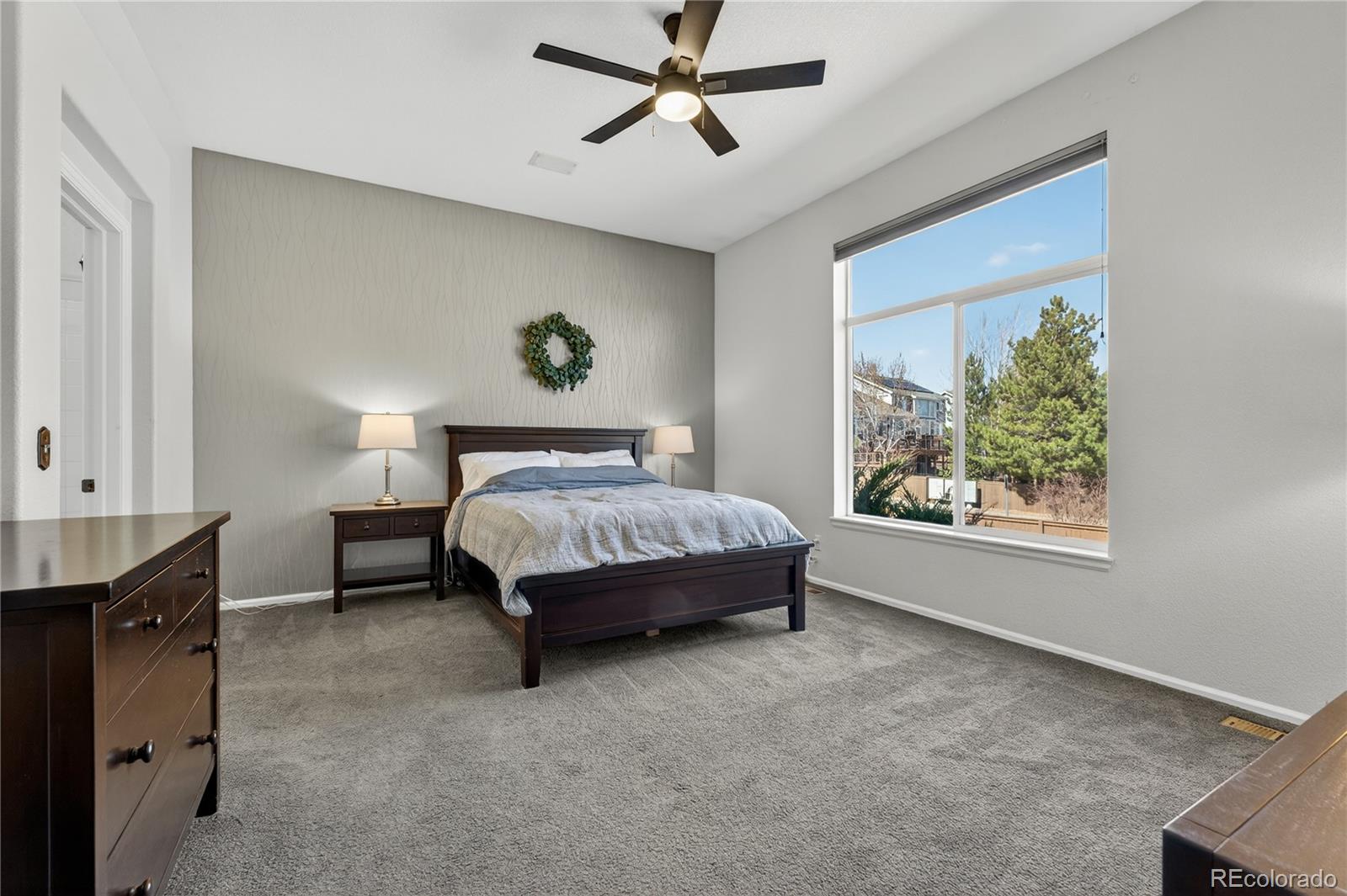 10155 Joseph Drive Highlands Ranch, CO 80124 - Photo 30 of 50 a spacious bedroom with a bed and a window