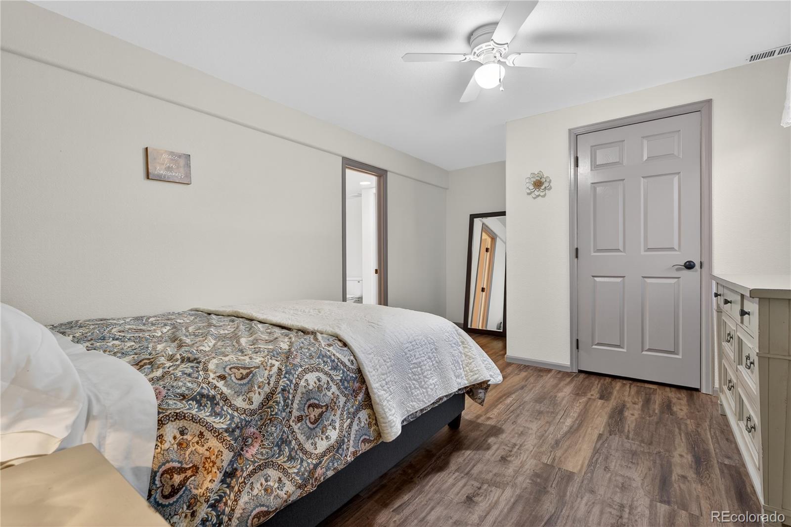 10155 Joseph Drive Highlands Ranch, CO 80124 - Photo 37 of 50 a bedroom with a bed and a chandelier