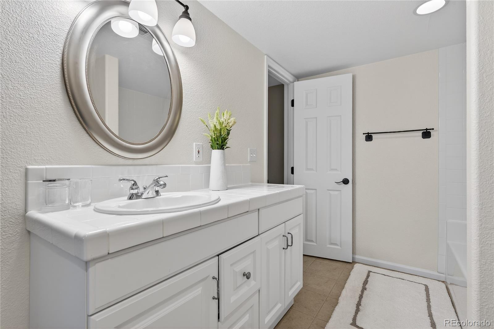 10155 Joseph Drive Highlands Ranch, CO 80124 - Photo 38 of 50 a bathroom with a sink and a mirror