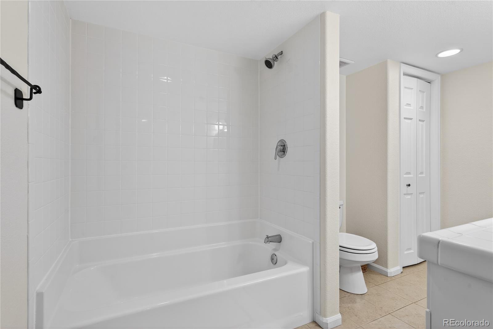 10155 Joseph Drive Highlands Ranch, CO 80124 - Photo 39 of 50 a white bath tub sitting next to a toilet