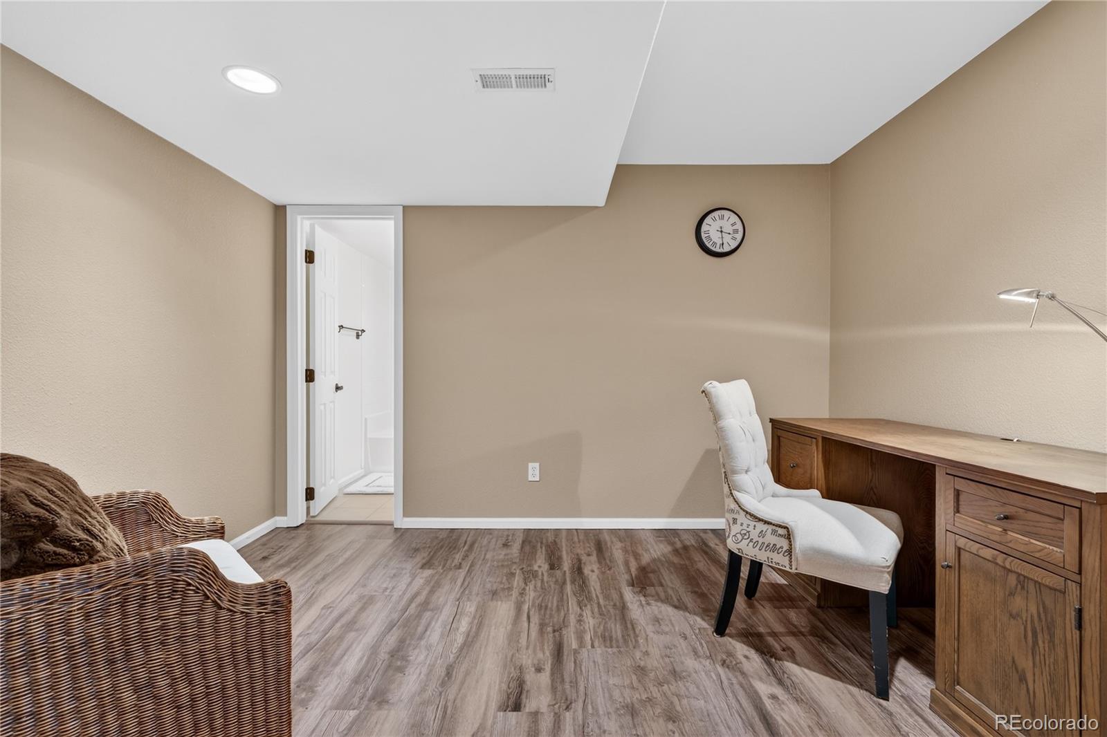 10155 Joseph Drive Highlands Ranch, CO 80124 - Photo 40 of 50 a bedroom with a bed and a chair