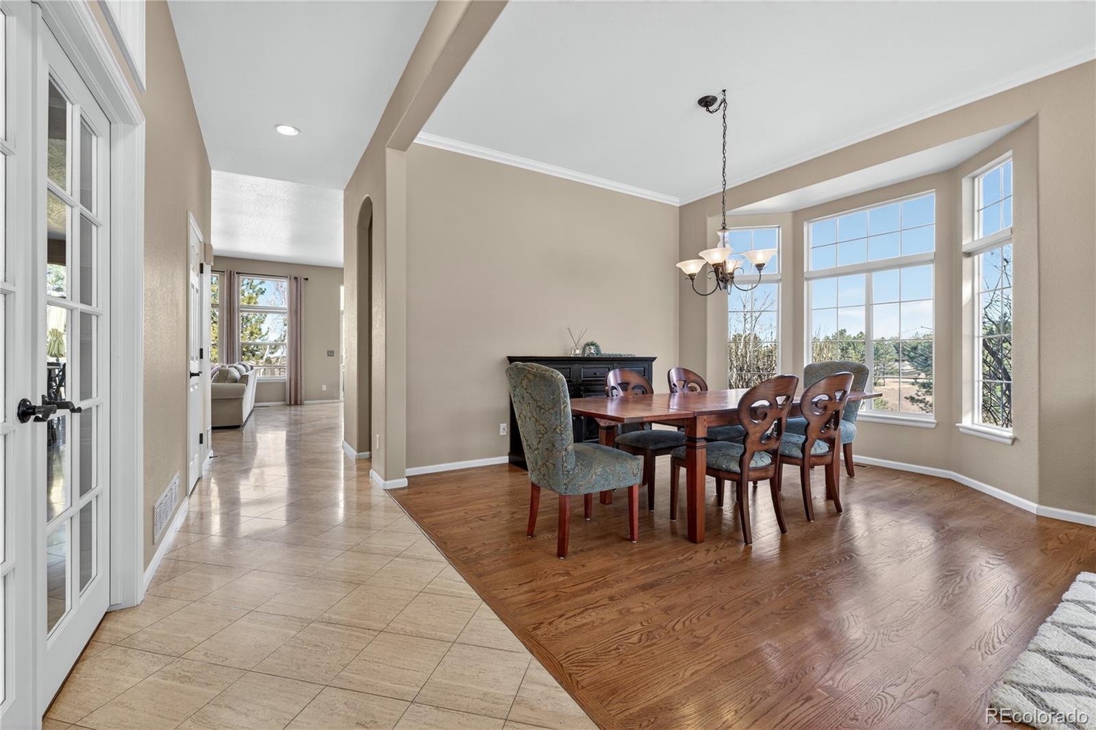 10155 Joseph Drive Highlands Ranch, CO 80124 - Photo 5 of 50 a view of a dining room with furniture and chandelier