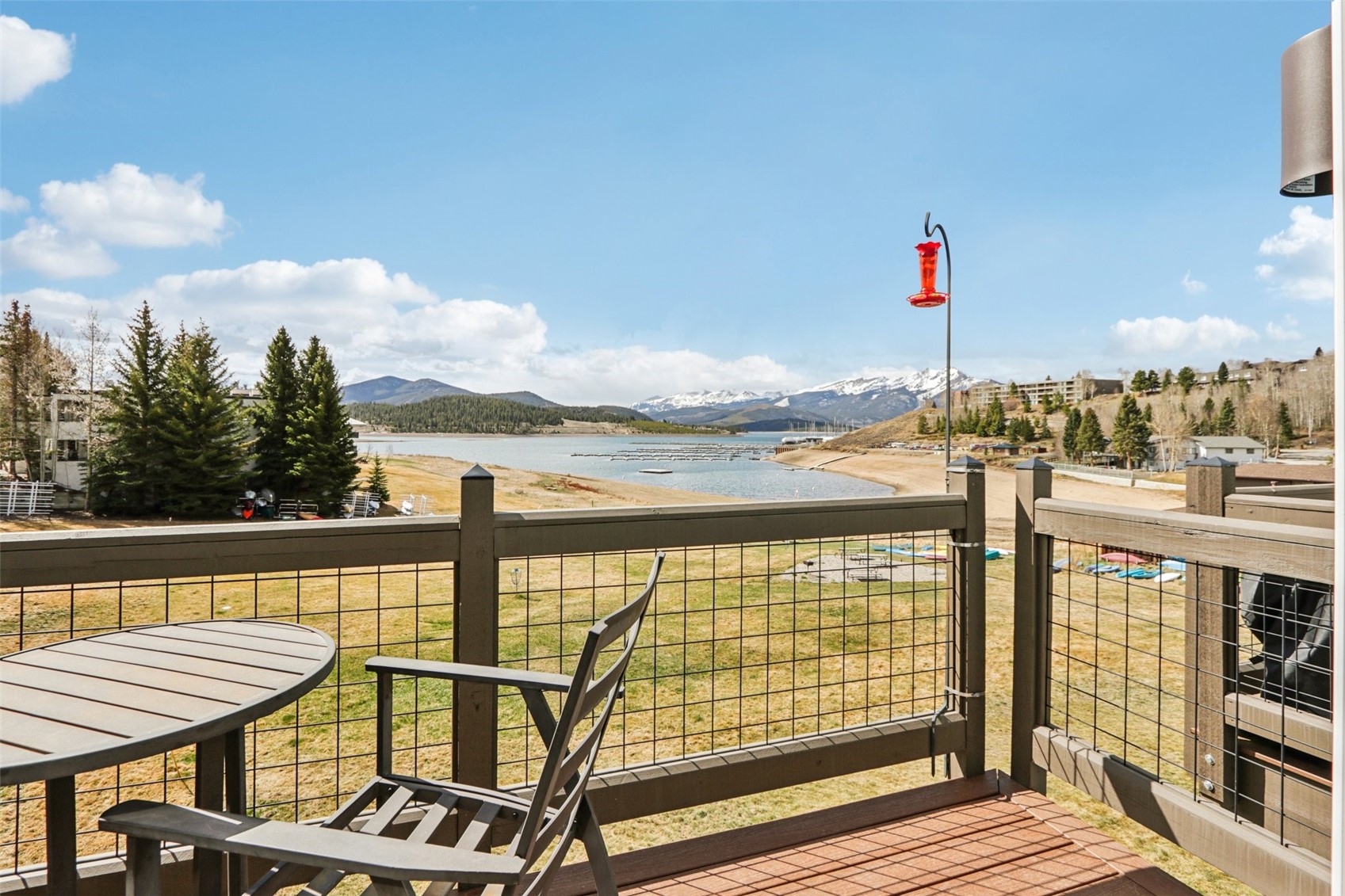 a view of a balcony with lake view and wooden floor