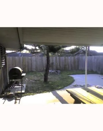 a view of swimming pool in back yard of the house