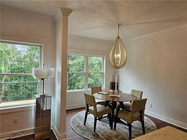 a dining room with a wooden table and chairs