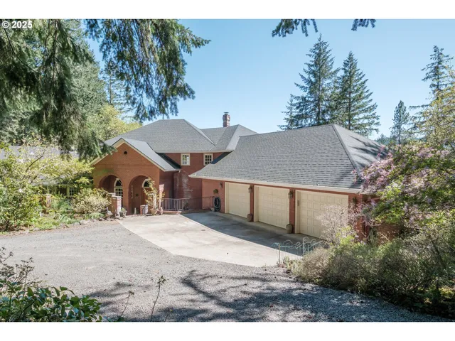 a view of a house with a yard and tree