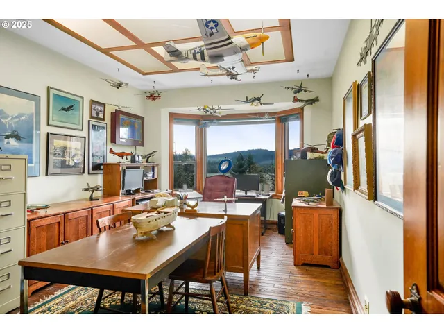 a view of a dining room with furniture a chandelier and wooden floor
