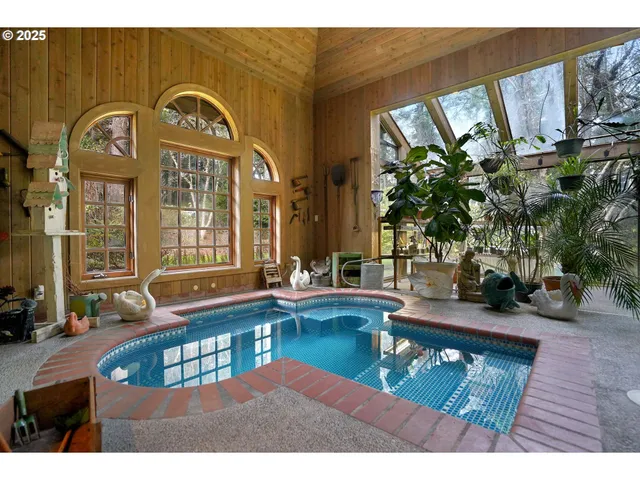 a living room with fireplace furniture and a potted plant