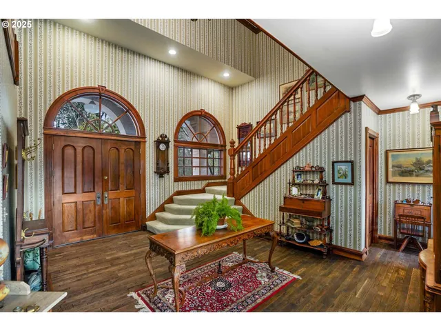 a view of entryway with wooden floor and stairs