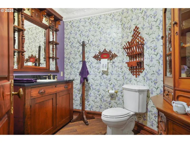 a bathroom with a toilet sink and mirror