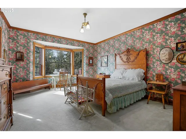 a bedroom with furniture and a large window