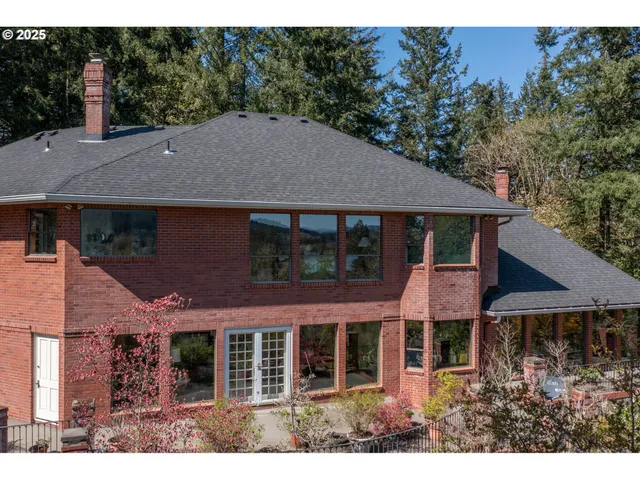a aerial view of a house with a yard and balcony