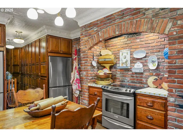 a kitchen with stainless steel appliances kitchen island granite countertop a stove and cabinets