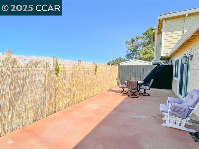 232 O'Neil Circle Hercules, CA 94547 - Photo 12 of 12 a view of a patio with a table and chairs under an umbrella with a small yard