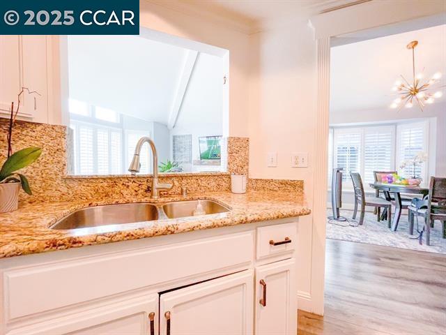 232 O'Neil Circle Hercules, CA 94547 - Photo 7 of 12 a view of a kitchen with kitchen island a counter top a stove and wooden floors