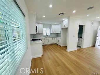 a large kitchen with kitchen island a sink stainless steel appliances and cabinets