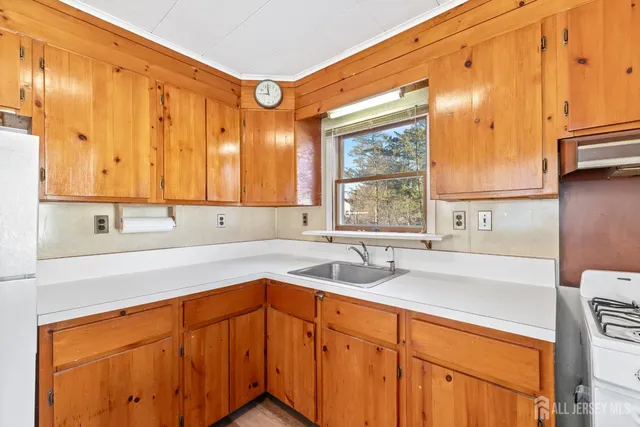 a kitchen with a sink cabinets and window
