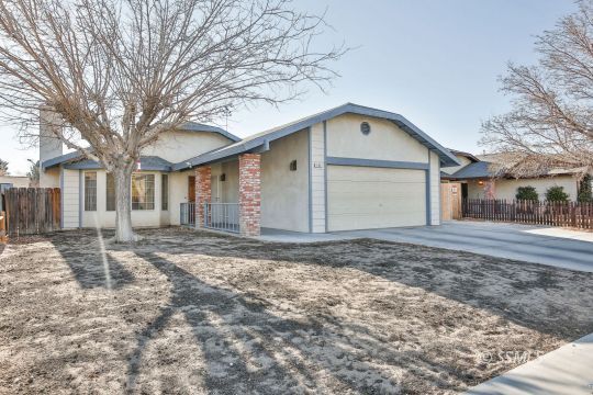 205 North Broadway Street Ridgecrest, CA 93555 - Photo 1 of 29 a front view of a house with a yard and garage