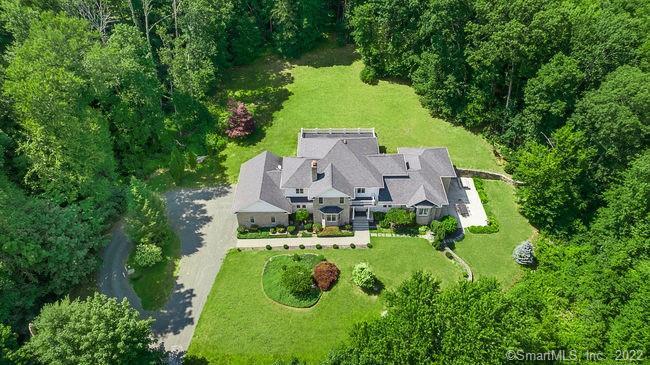 an aerial view of a house with yard swimming pool and outdoor seating