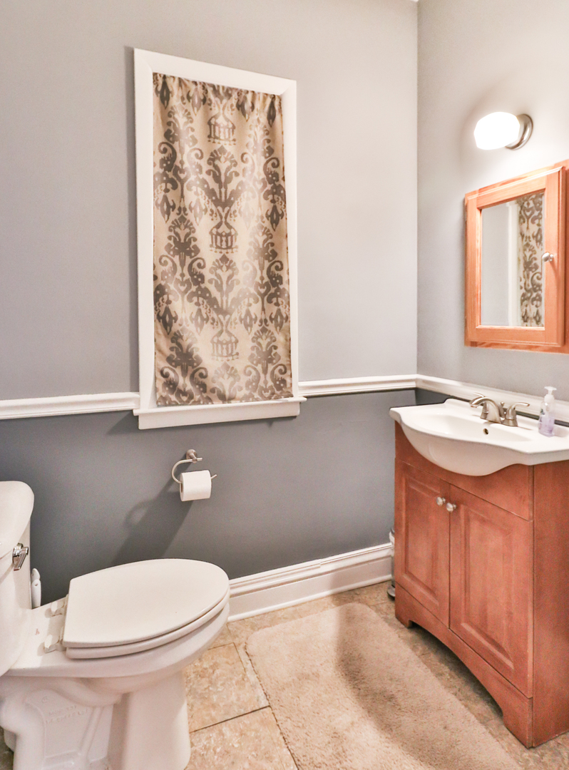 15 Rugby Place Elgin, IL 60120 - Photo 11 of 24 a bathroom with a granite countertop toilet sink and mirror