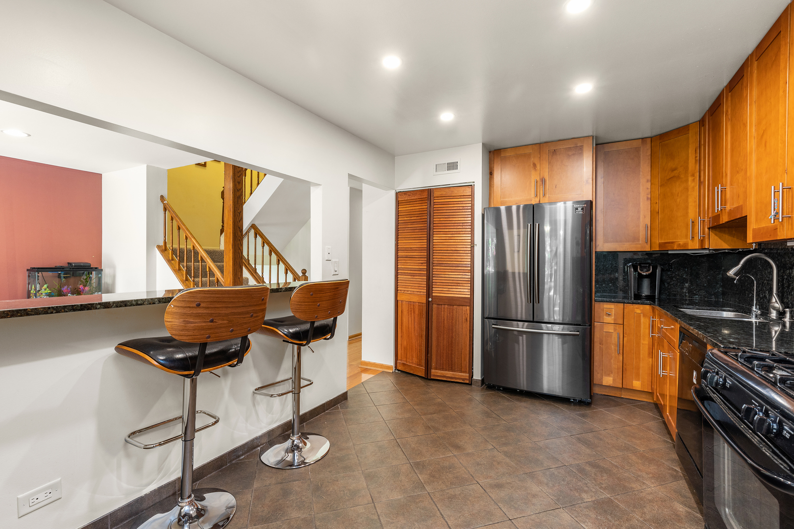 833 Swallow Street Deerfield, IL 60015 - Photo 11 of 37 a kitchen with stainless steel appliances granite countertop a refrigerator and a stove top oven