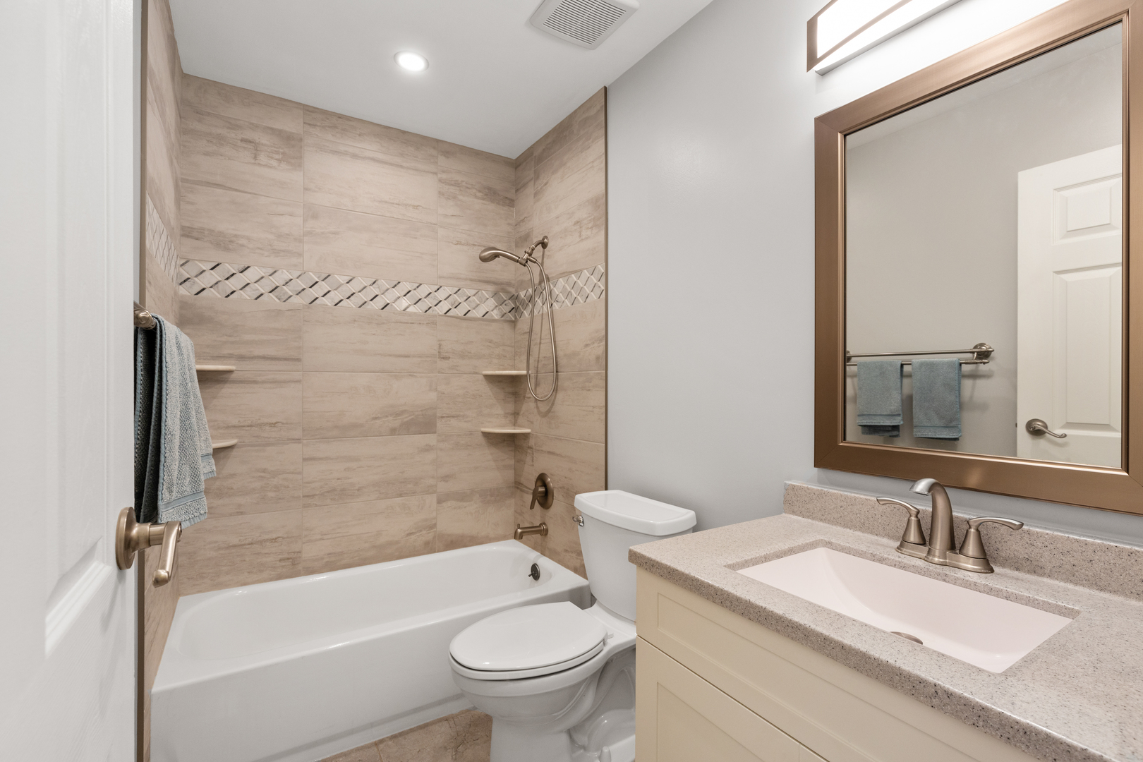 833 Swallow Street Deerfield, IL 60015 - Photo 17 of 37 a bathroom with a granite countertop toilet a sink and a bathtub