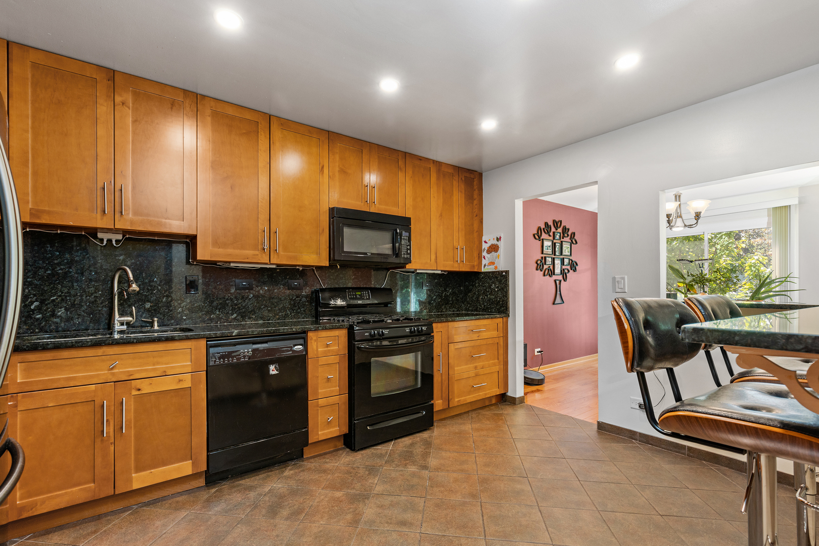 833 Swallow Street Deerfield, IL 60015 - Photo 10 of 37 a kitchen with stainless steel appliances granite countertop a stove a sink and a microwave