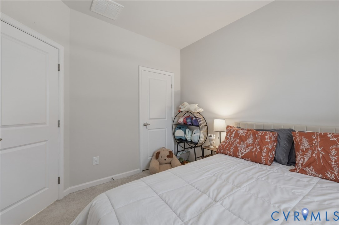 2031 Turtle Parkway Sandston, VA 23150 - Photo 19 of 26 a bedroom with a bed and a wooden floor